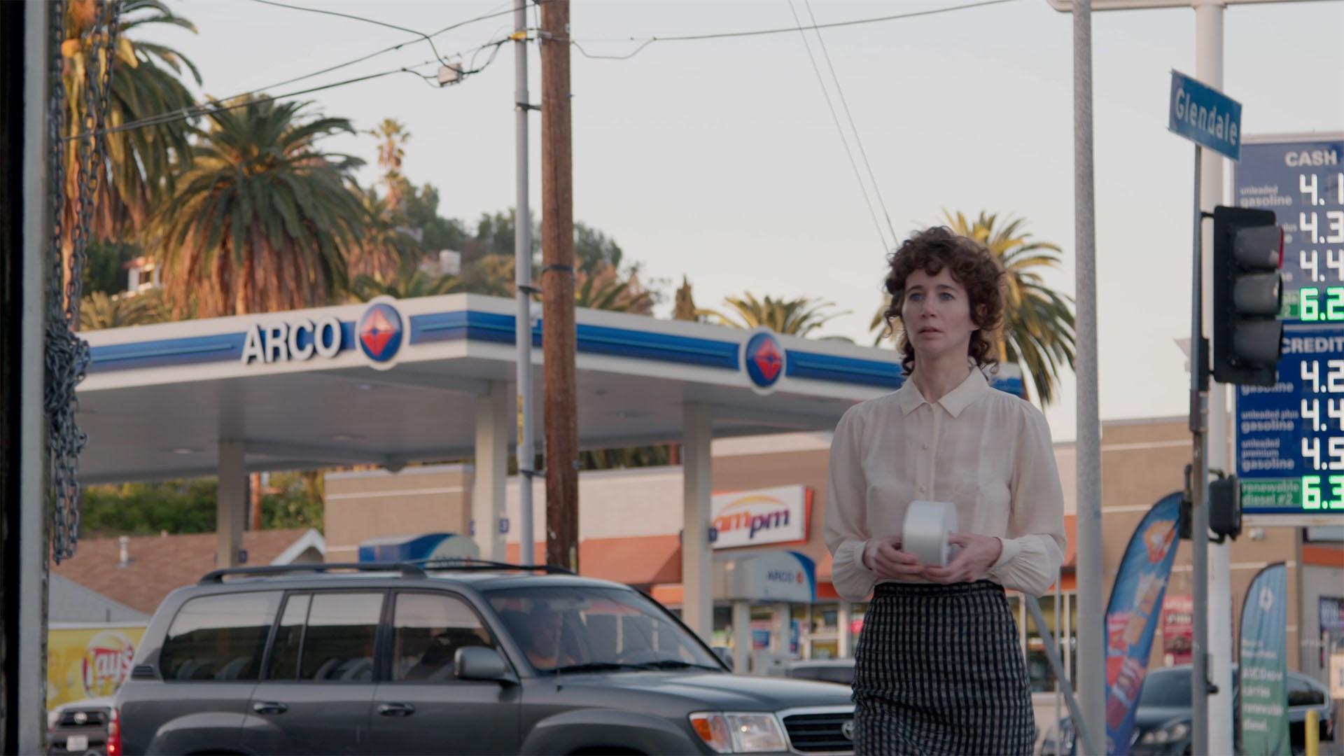 Miranda July performing at a gas station in Los Angeles, CA.