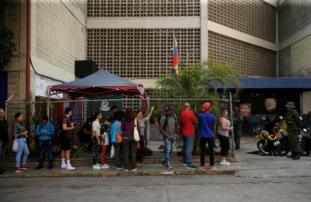 People stand in line to register to vote and to update their voting centres for the July 28 presidential elections, as the U.S. State Department announced it will not renew a temporary license that widely eased sanctions on Venezuela's oil and gas sector, unless progress is made by President Nicolas Maduro on commitments for free and fair elections this year, in Caracas, Venezuela April 16, 2024. Photo by Leonardo Fernandez Viloria/Reuters